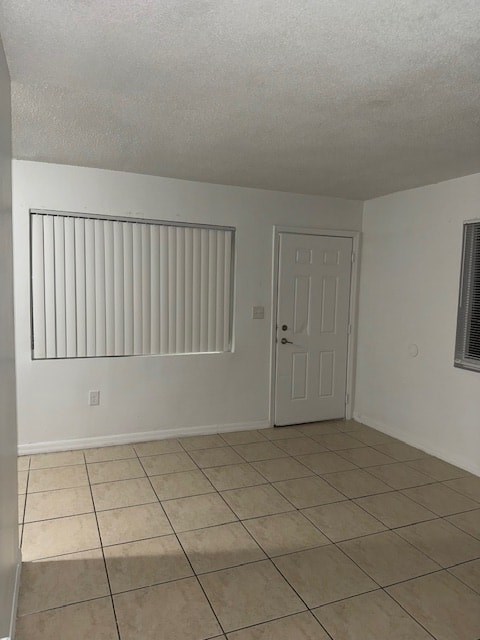 A room with a white door and a window with blinds.