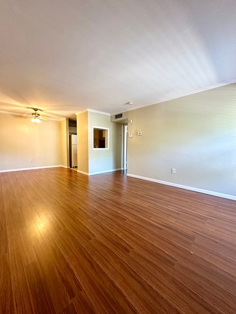 A room with wooden flooring and a light on the ceiling.