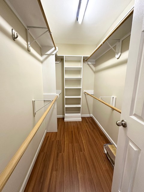 A hallway with a staircase and white walls.