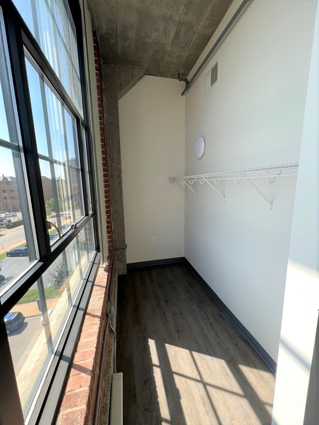 A room with a white wall and a shelf.