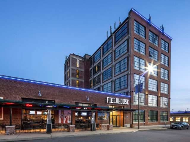 The Fieldhouse is a large, multi-story building with a flat roof and a brick exterior.