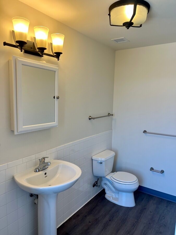 A white sink and toilet in a bathroom.