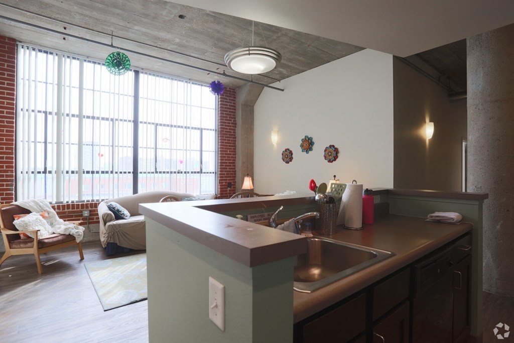 A kitchen with a sink and a window.