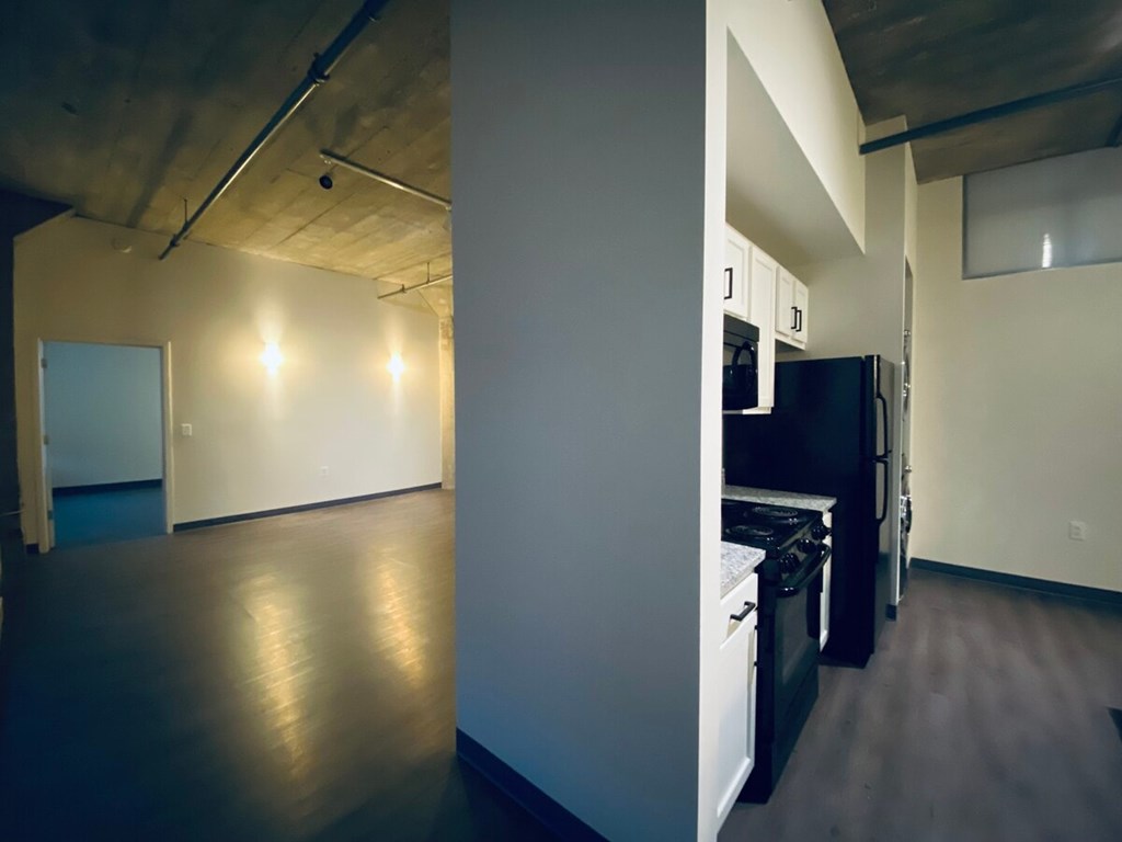 A kitchen area with a refrigerator, oven, and microwave.