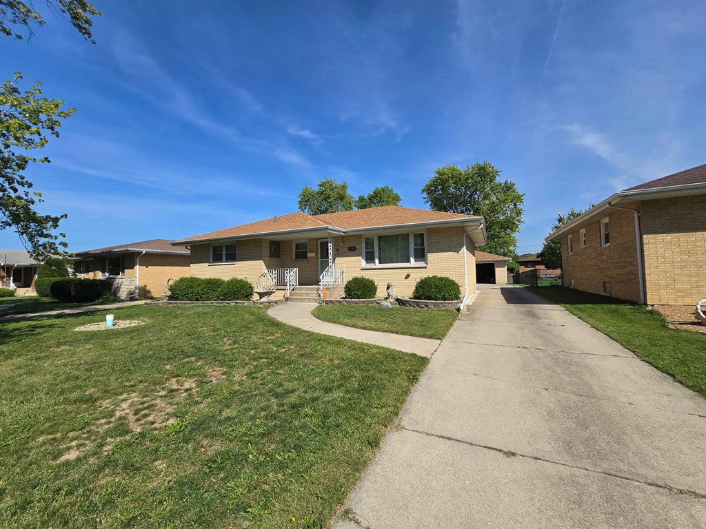 A residential area with houses and a clear sky.