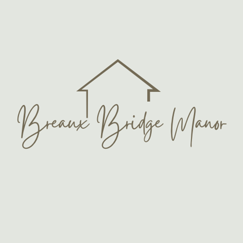 A logo with a house and the words "Breaux Bridge Manor" written underneath it.
