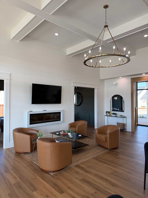 A modern living room with a fireplace and a television.