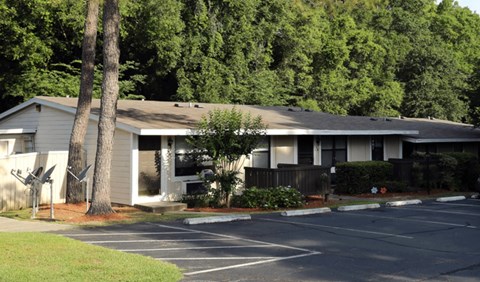 A building with a parking lot in front of it.