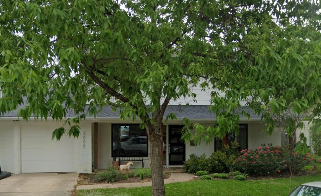 A house with a tree in front of it.