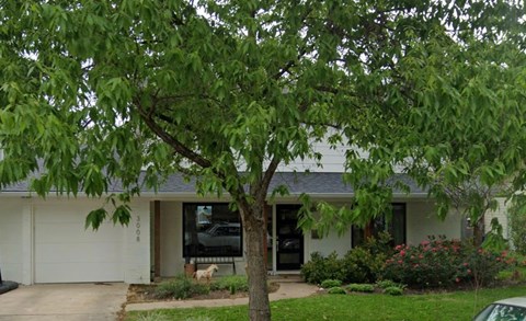 A house with a tree in front of it.