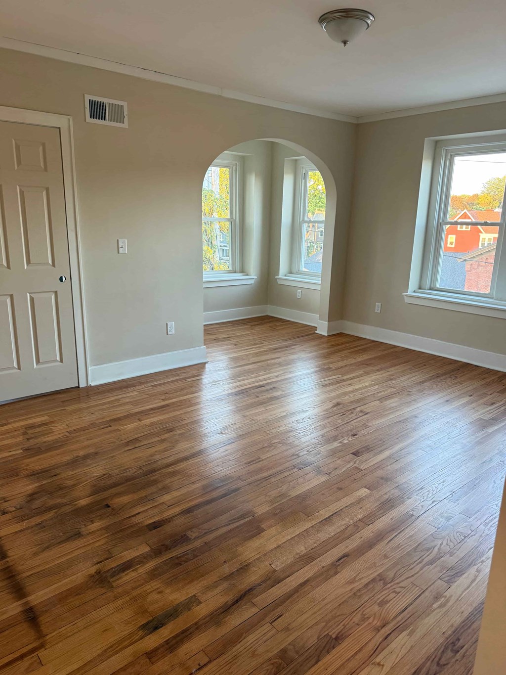 A room with wooden floors and white walls.