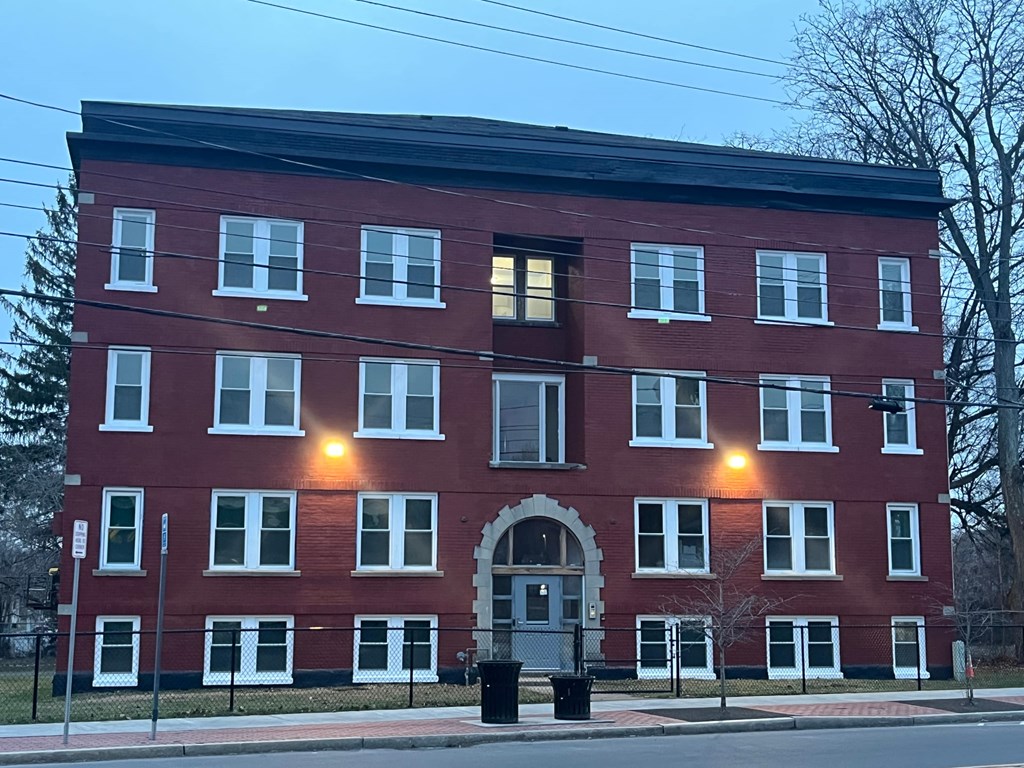A red brick building with white trim and windows.