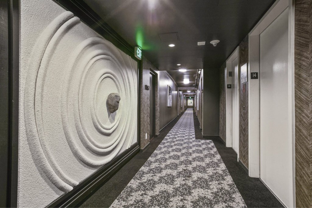 A hallway with a large circular design on the wall.