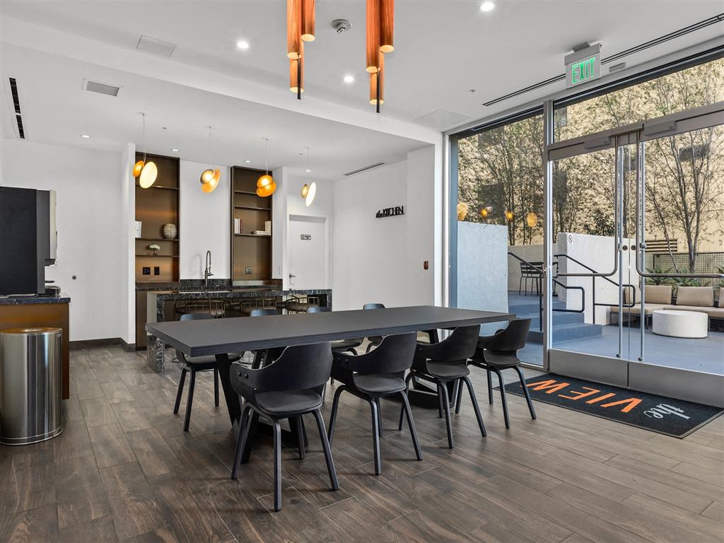 A modern kitchen with a dining table and chairs.