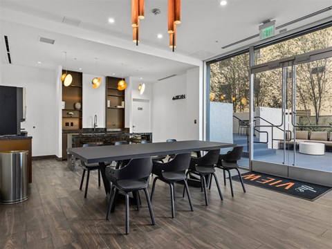 A modern kitchen with a dining table and chairs.