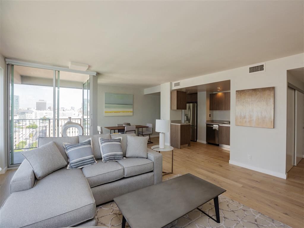 A living room with a grey couch and a coffee table.