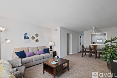 A living room with a grey couch and a brown coffee table.