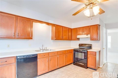 A kitchen with wooden cabinets and a black oven.