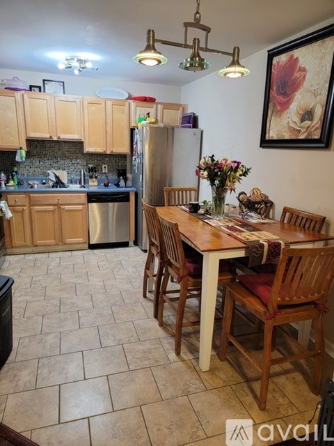 A kitchen with a table and chairs set for dining.