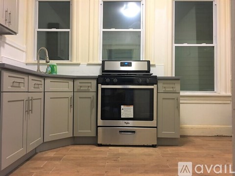 A kitchen with a stove and oven in the middle.