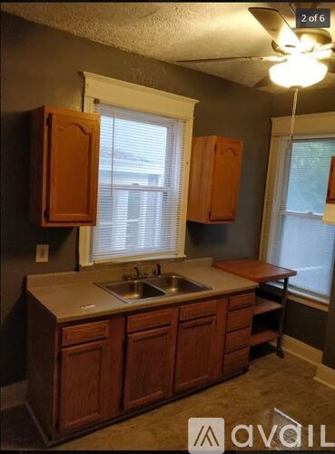 A kitchen with wooden cabinets and a window.