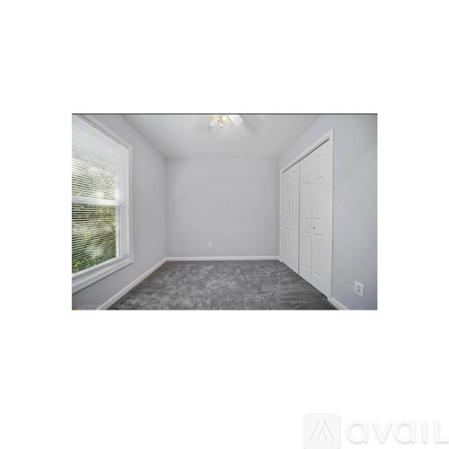 A room with a window and a door.