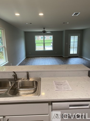 A kitchen with a sink and a window.