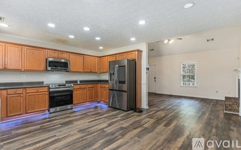 A kitchen with wooden cabinets and a refrigerator.
