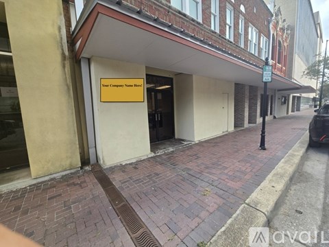 A building with a sign that says "Your Company Name Here" is shown.