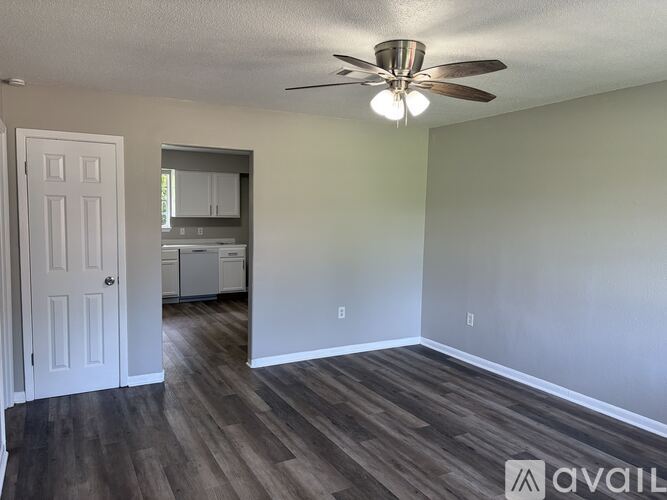 A kitchen with white appliances and cabinets.