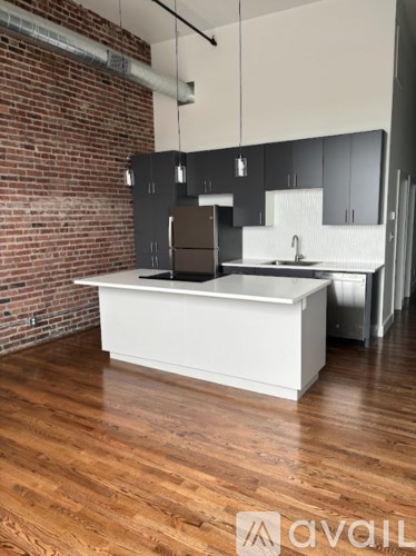 A kitchen with a white island in the middle of it.