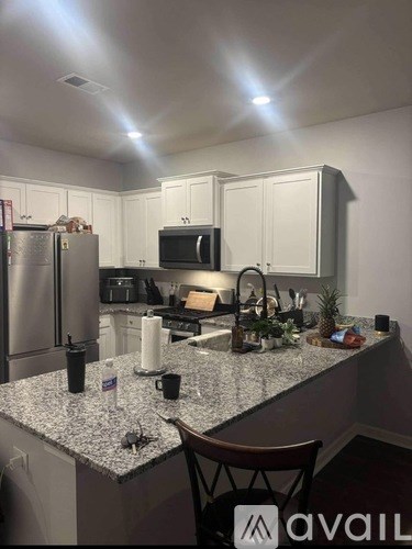 A bathroom with a sink, mirror, and a phone on the counter.
