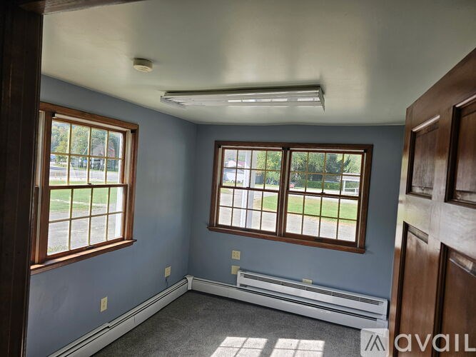 A room with a window and a door.