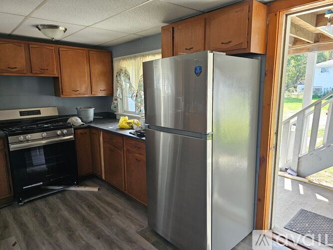 A kitchen with a refrigerator, stove, and oven.