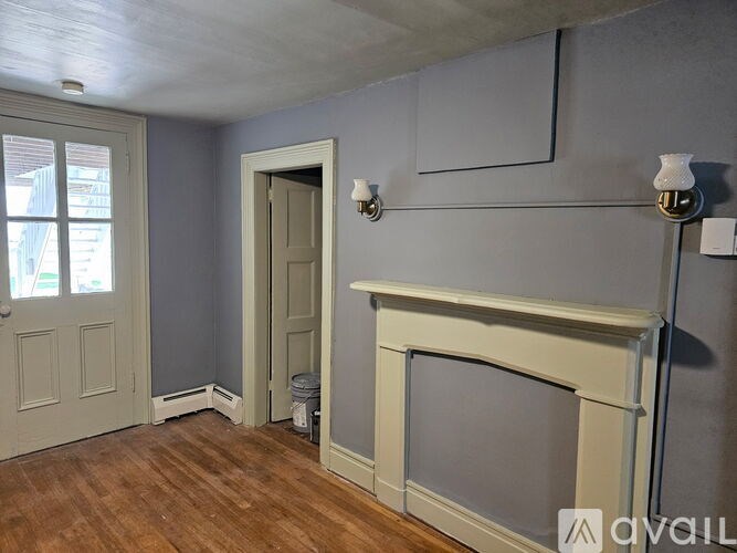 A room with a fireplace and a door.