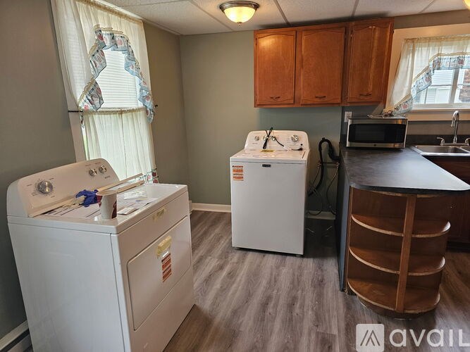 A small laundry room with a washer and dryer.
