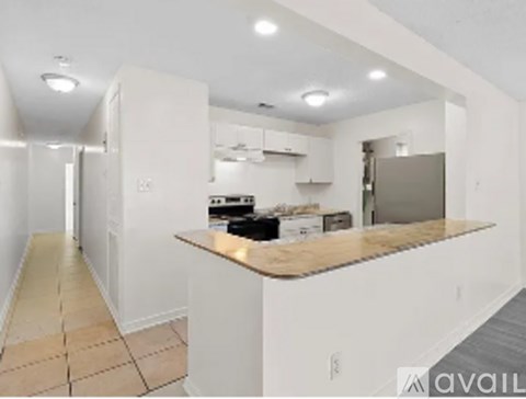 A kitchen with a counter top and a refrigerator.