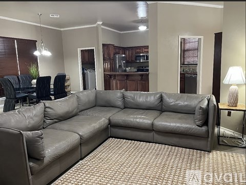 A grey leather sectional sofa in a living room.