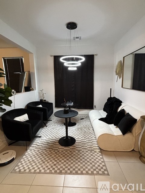 A black and white living room with a round table and chairs.