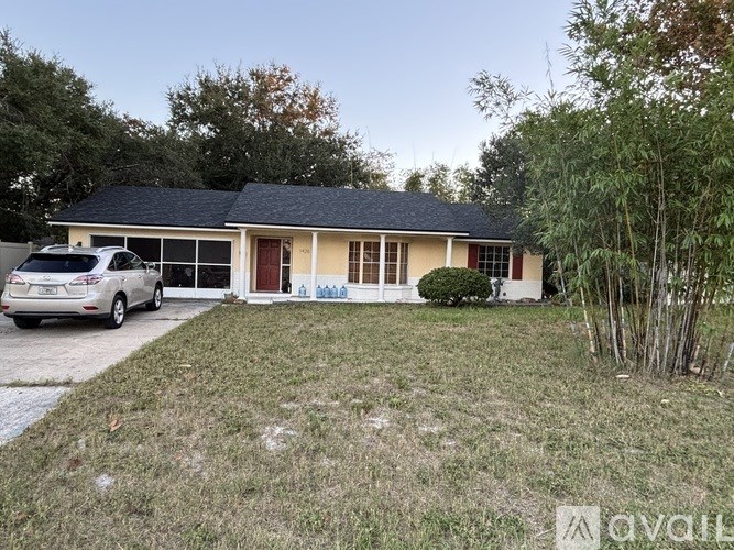 A house with a car parked in front of it.
