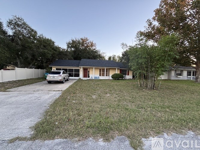A house with a driveway and a car parked in front.