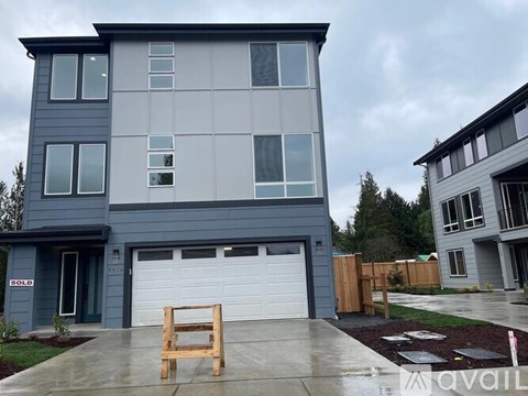 A modern two-story house with a garage is for sale.