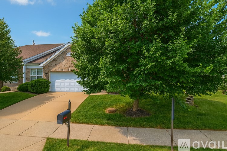 A house with a driveway and a mailbox.
