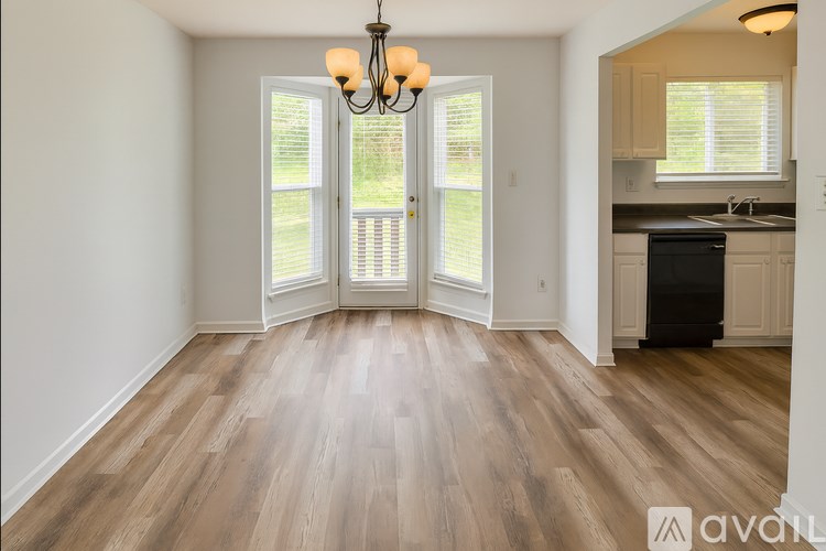 A room with wooden floors and a chandelier.