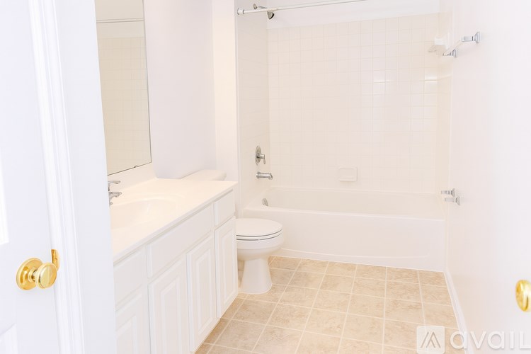 A bathroom with a toilet, sink, and bathtub.