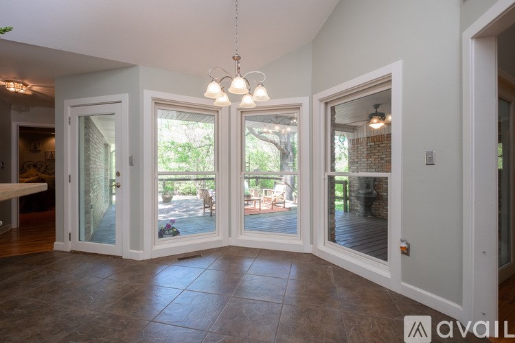 A room with a tiled floor and a chandelier hanging from the ceiling.
