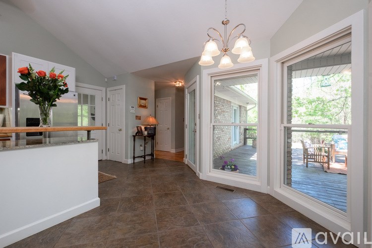 A living room with a bar area and a dining table.