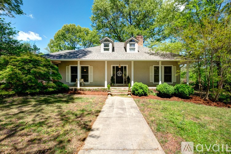 A house with a front yard and a walkway leading to the front door.