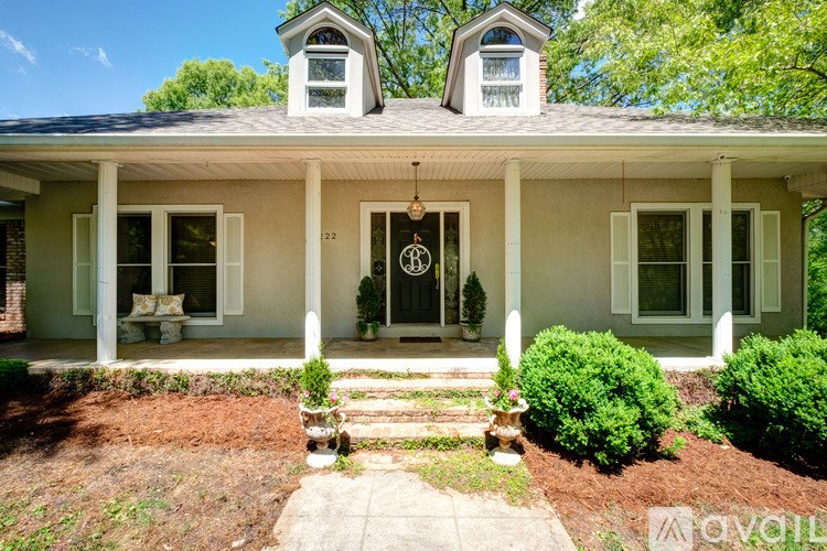 A house with a front porch and a small garden.
