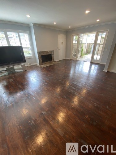 A living room with a television and a fireplace.